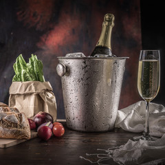 Champagne in the glass with bread and vegetables.
