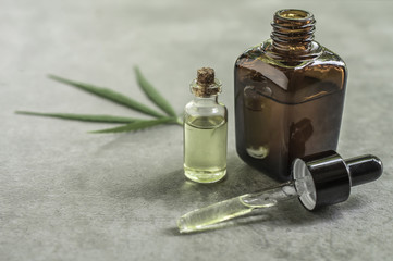 cannabis essential oil container with cannabis leaves