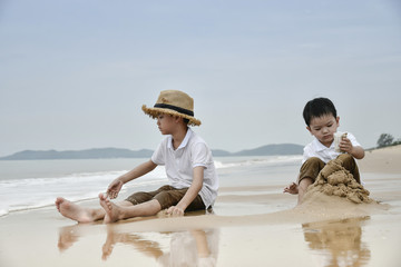 Fototapeta na wymiar happy family with two kids on the beach,