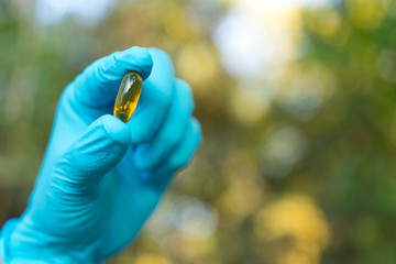 Hand holding chemistry science flask,Erlenmeyer flask over green bokeh background,concept for...