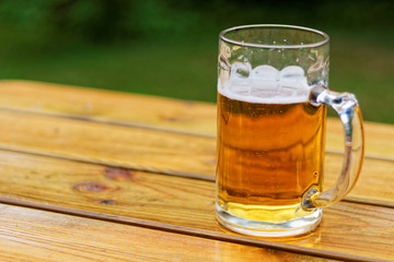 glass of beer on wooden table
