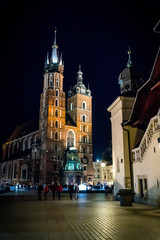 Fototapeta na wymiar Basilique Sainte-Marie sur la Place Rynek Głowny à Cracovie de nuit