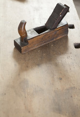 carpenter hand plane on wooden background.copy space