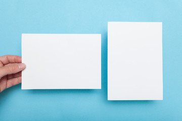 Paper blank brochure in hand, flyer mockup.