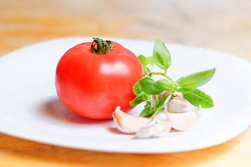 Tomato, basil and garlic on the plate