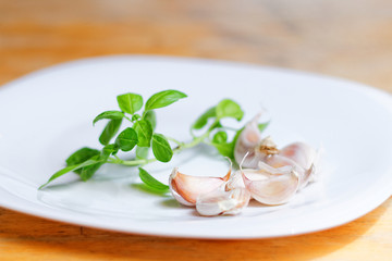 Basil leaves and garlic on the plate