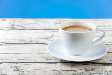 A cup of cofee on a wooden surface