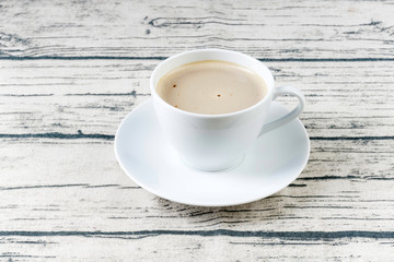 A cup of cofee on a wooden surface