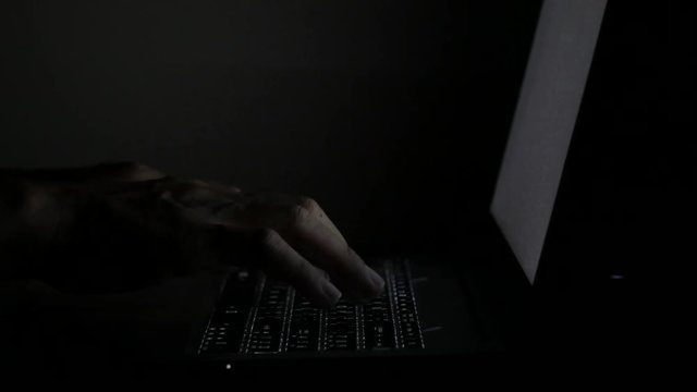 close up  typing keyboard laptop computer black screen on the table in the dark room , checking e-mail and working concept