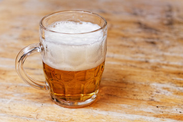 Glass of beer on a wooden table