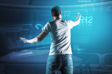 Large screen. Smart experienced programmer putting his hand up while touching the transparent screen of his futuristic device