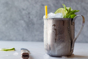 Moscow Mule Cocktail with Lime, Mint Leaves and Crushed Ice in Metal Cup.