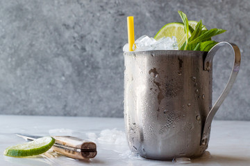 Moscow Mule Cocktail with Lime, Mint Leaves and Crushed Ice in Metal Cup.