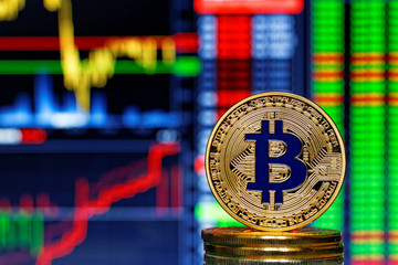 Golen bitcoin and stock's charts in the background