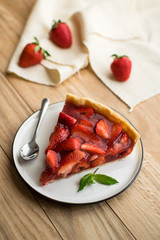 strawberry tart on wooden background.