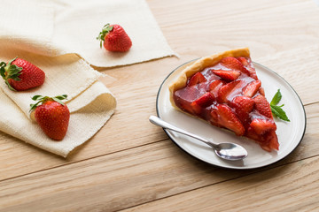 strawberry tart on wooden background.