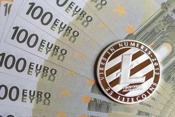 Silver litecoin and euro banknotes