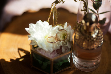 Fototapeta na wymiar Wedding rings on a wooden texture surface