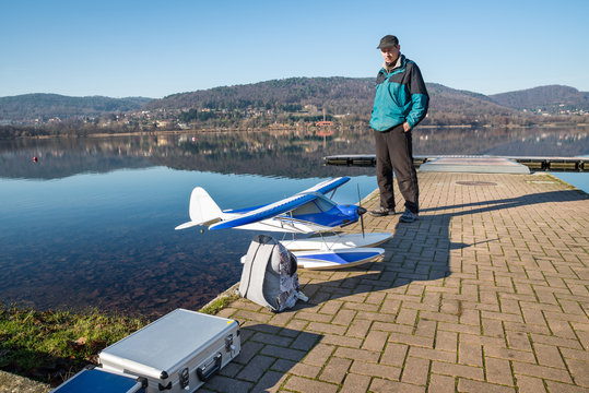 Radio Controlled (RC) seaplane. Float plane model on the shore of a lake ready to fly. Lake Comabbio, Corgeno, Italy