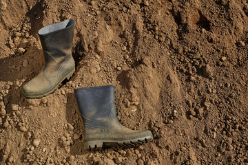 Worker boots on soil.