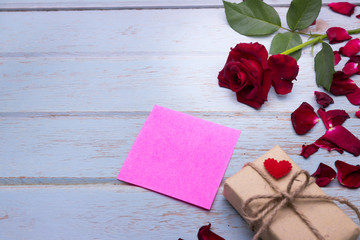 Red roses on wooden board background with copy space