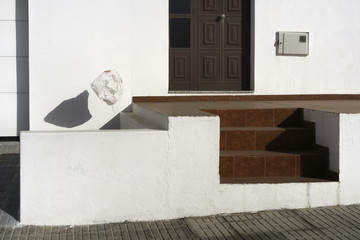 Plastic bag blown in the wind over a front doorstep.