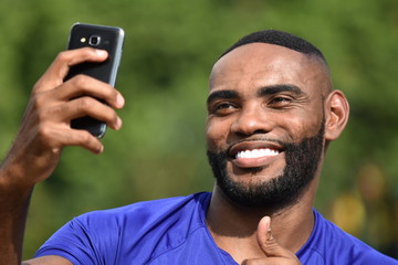 Male Athlete Using Cell Phone And Happy