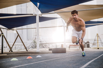 Beautiful man doing work out and different exercises outdoor