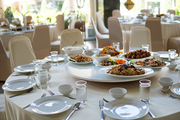 catering table set service with silverware and glass stemware at restaurant before party