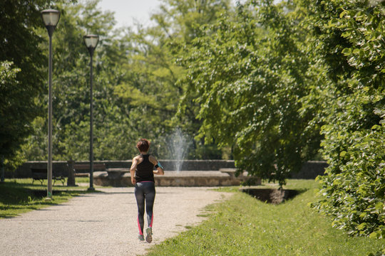 sportive woman jogging (no image editing), training at park
