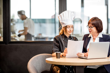 Senior chef and young cook at the restaurant