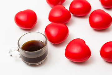 Cup of coffee with hearts on white table. Top view with copy space. Valentine's day background
