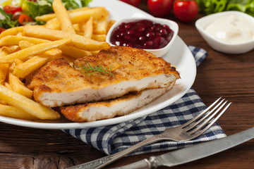 Chicken schnitzel, served with fries and salad.