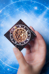 astrology concept with woman hand keeping a card with zodiac sign Saggitarius 