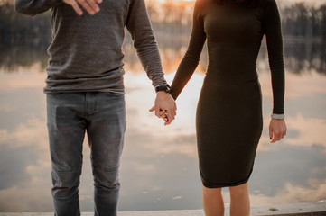 Couple standing on edge of rostroom on a lake