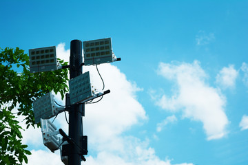 group of electric  lamp on  the pole with blue sky and white cloud