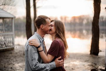 Naklejka premium Couple in love standing together on the background of lake