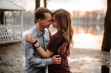 Naklejka premium Couple in love hugging each other on the background of beautiful lake