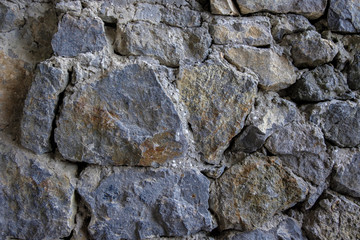 Old stone wall rustic texture background. Blue and gray retro stone wall background. Brick rock texture