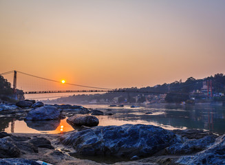 Obraz premium View of River Ganga and Ram Jhula bridge silhouette Rishikesh. India. 