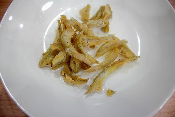 Dried fish in a white dish
