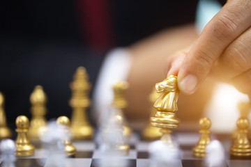 hand of businessman playing chess.