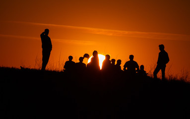 Fototapeta na wymiar People silhouettes watching the sunset