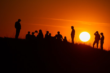 Silhouettes of people on sunset