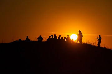 Fototapeta na wymiar Group of people watching the sunset