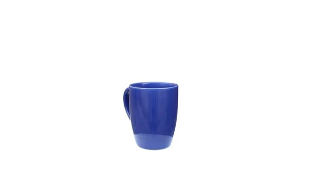 blue ceramic cup rotating on isolated white