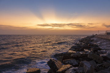 Fototapeta na wymiar Colorful sunset on a beach with rocks on the Adriatic Sea coast Istria