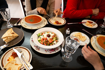 Family dinner with Greek salad and on the dinner