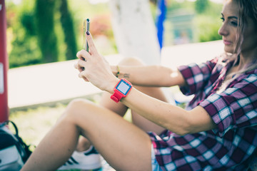 BUCHAREST, ROMANIA, - October 26, 2017: Person using smart watch and a smartphone walking on the park in a sunday. Woman making gestures on a wearable smart watch. Illustrative editorial content.