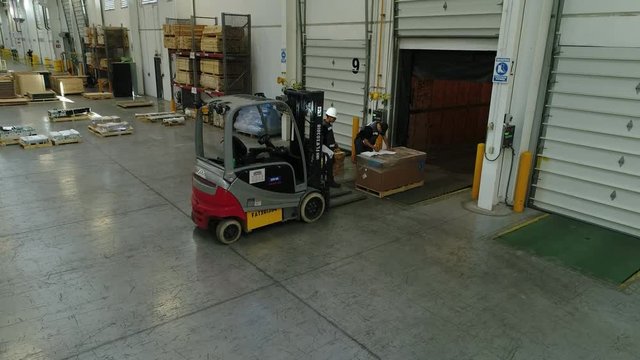 Men preparing to load pallet for shipment